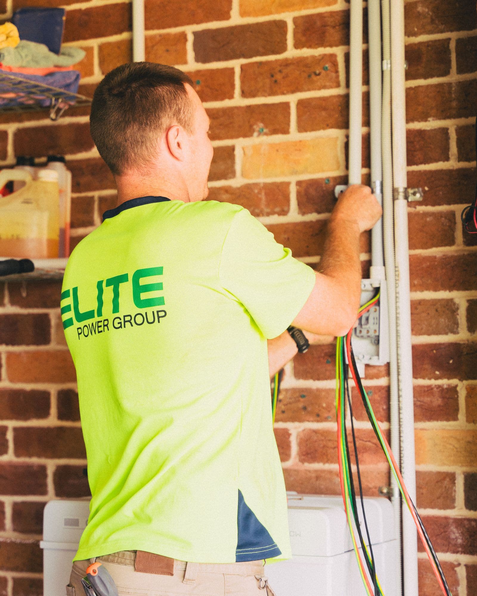 Cameron running low-voltage cable during a clean home install